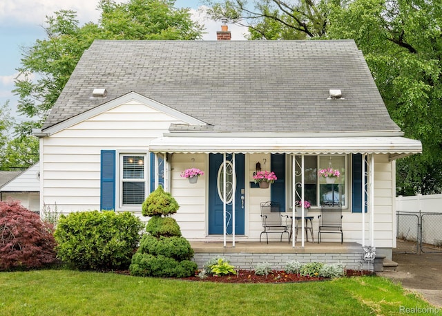 625 Whitcomb Ave, Royal Oak, MI 48073 - view of front facade featuring a porch, a shingled roof, and a chimney