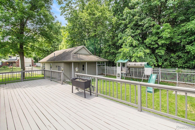 11275 Grand Oaks Dr, Clio, MI 48420 - deck featuring a playground and view of scattered trees