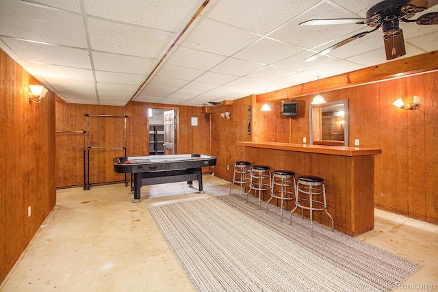11275 Grand Oaks Dr, Clio, MI 48420 - recreation room with wood walls, a dry bar, concrete floors, a drop ceiling, and ceiling fan
