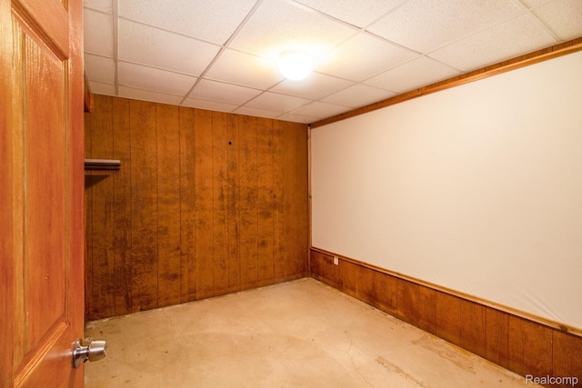 11275 Grand Oaks Dr, Clio, MI 48420 - spare room featuring wood walls, concrete flooring, and a drop ceiling