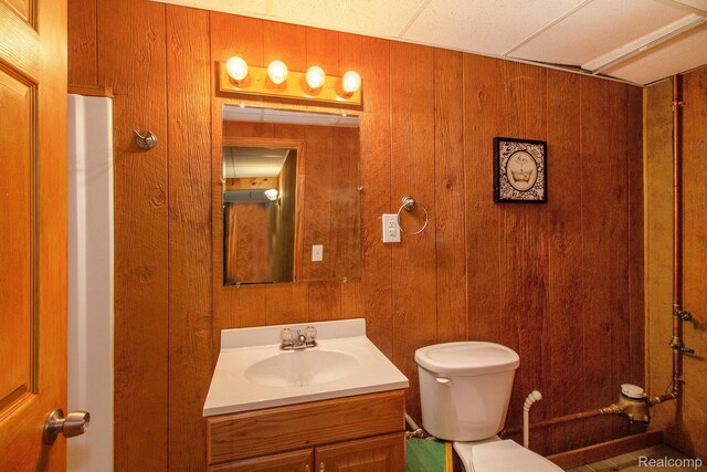 11275 Grand Oaks Dr, Clio, MI 48420 - bathroom featuring vanity and wooden walls