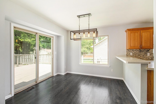 11275 Grand Oaks Dr, Clio, MI 48420 - unfurnished dining area with plenty of natural light and dark wood finished floors