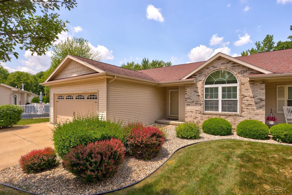 16 Rose Cottage Ln, Saginaw, MI 48609 - ranch-style house featuring a garage, brick siding, driveway, and a shingled roof