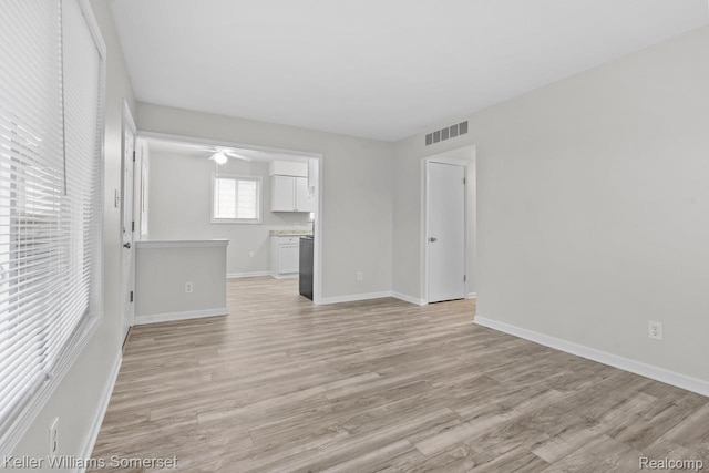7568 Dodge Ave, Warren, MI 48091 - unfurnished living room with light wood-style flooring and a ceiling fan