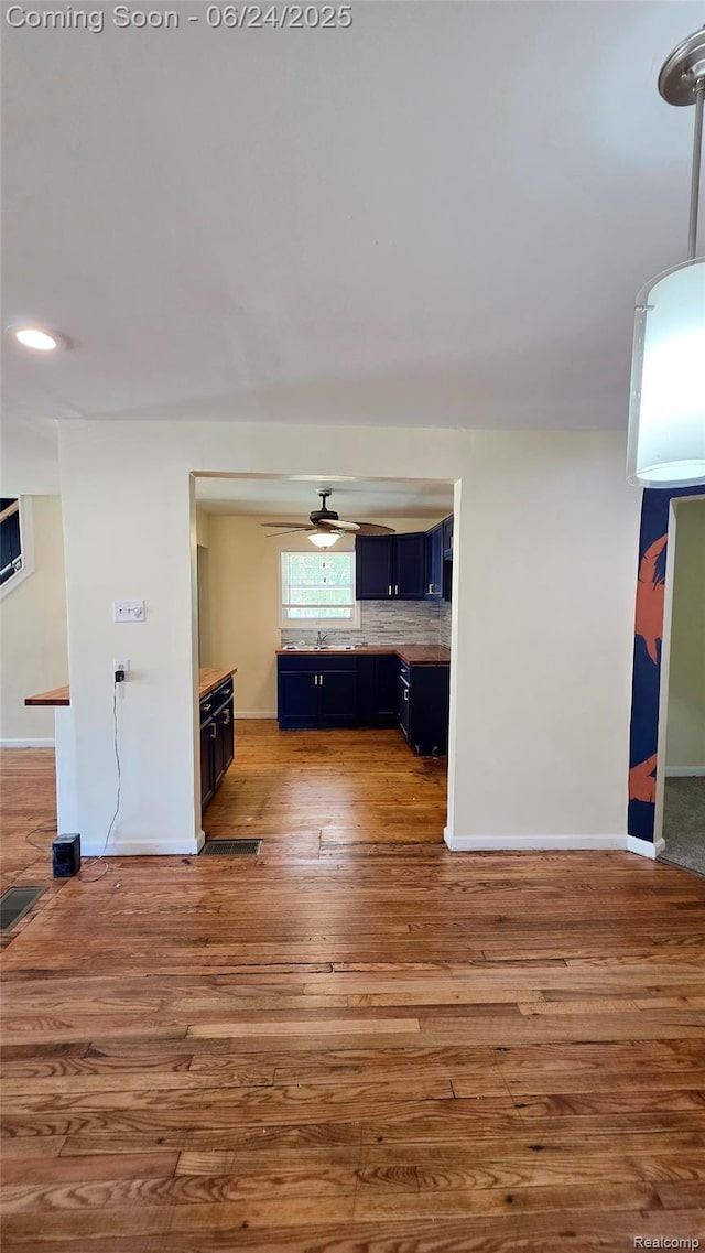 12280 Wade St, Detroit, MI 48213 - unfurnished living room with wood finished floors, a ceiling fan, and recessed lighting