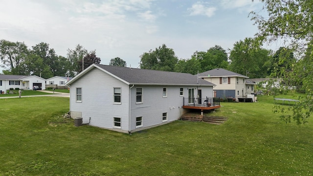 56570 Warren Dr, Dowagiac, MI 49047 - back of property featuring a yard, a deck, and roof with shingles