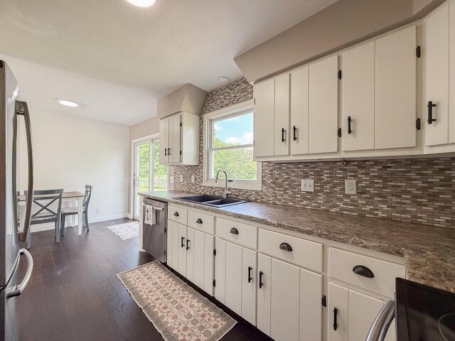 56570 Warren Dr, Dowagiac, MI 49047 - kitchen featuring appliances with stainless steel finishes, dark wood-style floors, backsplash, and white cabinets