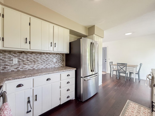 56570 Warren Dr, Dowagiac, MI 49047 - kitchen with freestanding refrigerator, dark wood-style floors, tasteful backsplash, and light countertops