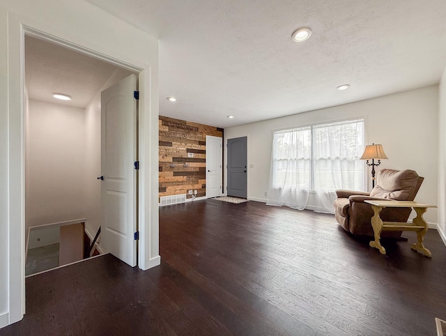 56570 Warren Dr, Dowagiac, MI 49047 - sitting room with wood walls, dark wood finished floors, recessed lighting, and an upstairs landing