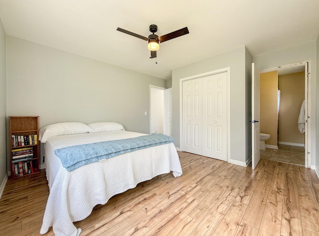 56570 Warren Dr, Dowagiac, MI 49047 - bedroom featuring light wood-style floors, a closet, a ceiling fan, and connected bathroom