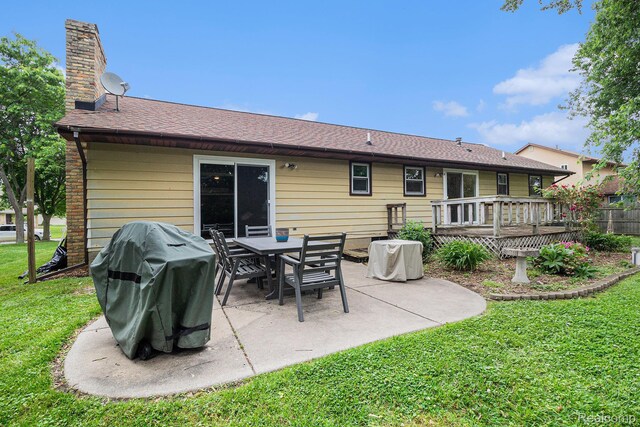 5369 Old Franklin Rd, Grand Blanc, MI 48439 - rear view of house with a lawn, a chimney, a patio, a deck, and a shingled roof