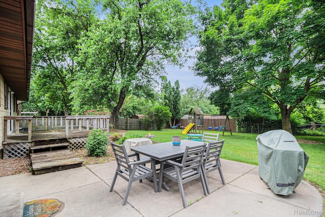 5369 Old Franklin Rd, Grand Blanc, MI 48439 - fenced backyard featuring a patio area, outdoor dining area, a playground, and a wooden deck