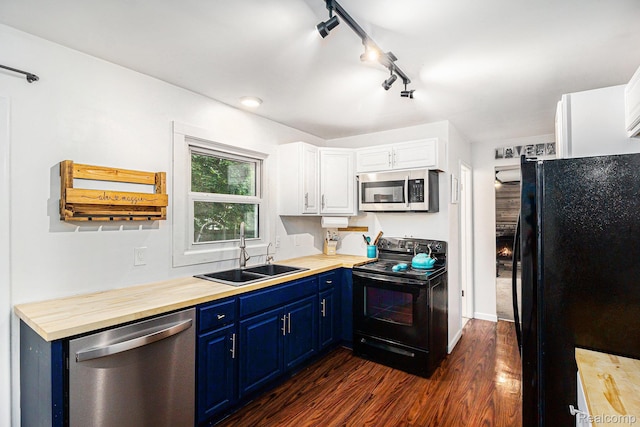 5369 Old Franklin Rd, Grand Blanc, MI 48439 - kitchen with black appliances, blue cabinets, dark wood-style floors, white cabinets, and rail lighting
