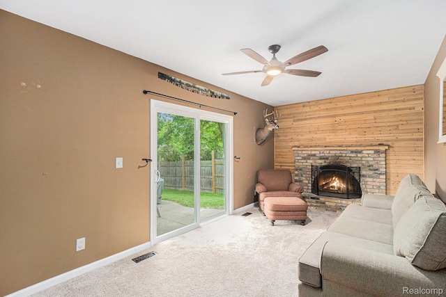 5369 Old Franklin Rd, Grand Blanc, MI 48439 - living room with ceiling fan, carpet, wood walls, and a brick fireplace