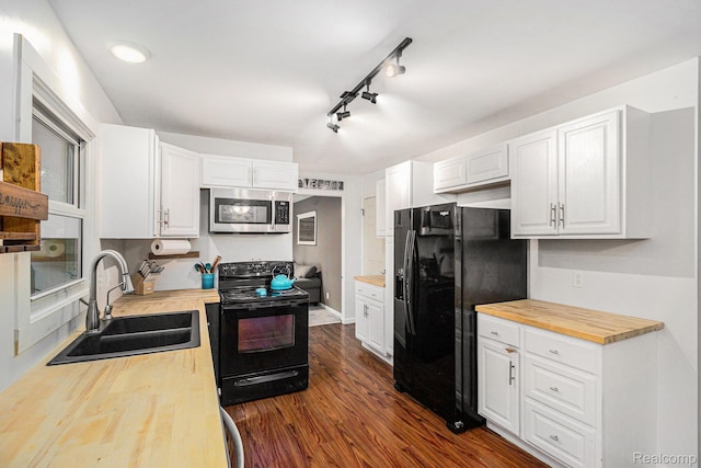5369 Old Franklin Rd, Grand Blanc, MI 48439 - kitchen featuring black appliances, wooden counters, dark wood-style floors, and white cabinetry