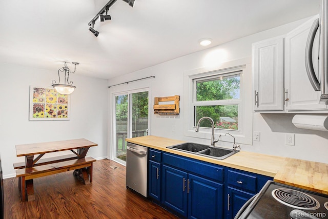 5369 Old Franklin Rd, Grand Blanc, MI 48439 - kitchen with blue cabinetry, stainless steel dishwasher, butcher block countertops, and healthy amount of natural light