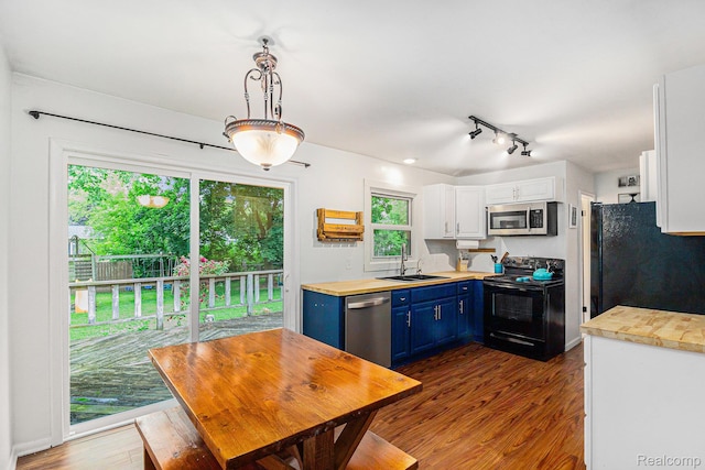 5369 Old Franklin Rd, Grand Blanc, MI 48439 - kitchen featuring black appliances, blue cabinetry, dark wood-style flooring, white cabinetry, and track lighting