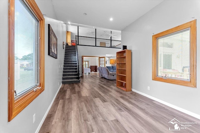 1617 Davis St, Wyandotte, MI 48192 - unfurnished living room with stairway, wood finished floors, plenty of natural light, and ceiling fan