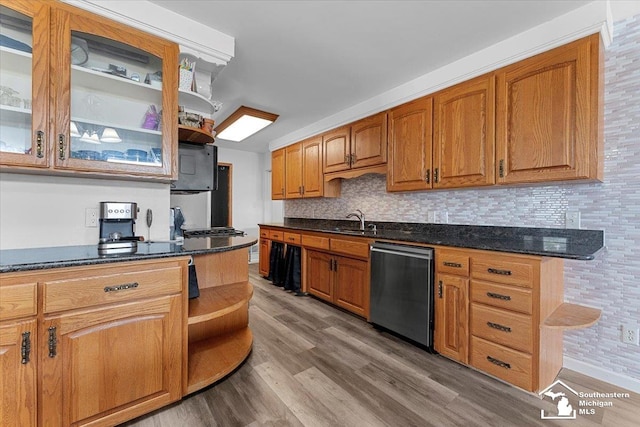 1617 Davis St, Wyandotte, MI 48192 - kitchen with stainless steel dishwasher, open shelves, wood finished floors, backsplash, and glass insert cabinets