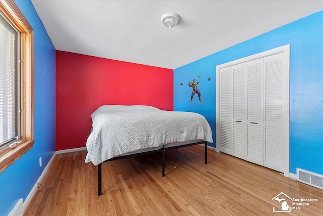 1617 Davis St, Wyandotte, MI 48192 - bedroom with wood finished floors, a closet, and baseboard heating