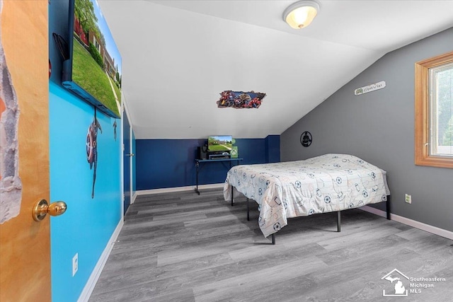 1617 Davis St, Wyandotte, MI 48192 - bedroom featuring vaulted ceiling and wood finished floors