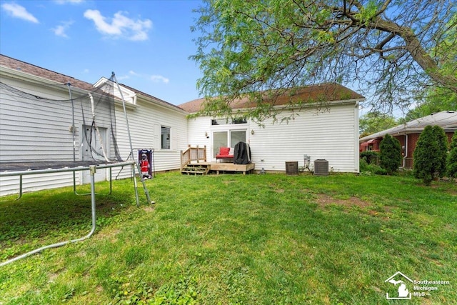 1617 Davis St, Wyandotte, MI 48192 - back of house with a wooden deck and a yard