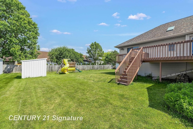 2364 Milford Dr, Saginaw, MI 48603 - fenced backyard with a playground, stairway, a storage unit, and a wooden deck