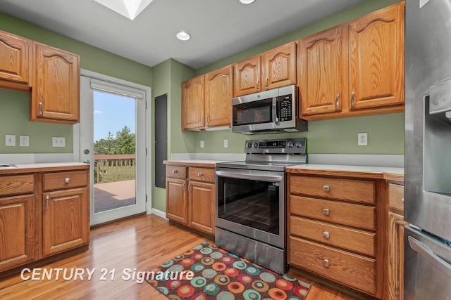 2364 Milford Dr, Saginaw, MI 48603 - kitchen with stainless steel appliances, light wood-style floors, light countertops, and recessed lighting