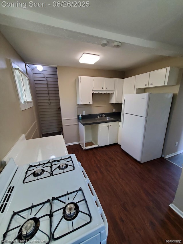 3909 Electric Ave, Port Huron, MI 48060 - kitchen featuring white appliances, dark wood-type flooring, dark countertops, and white cabinetry