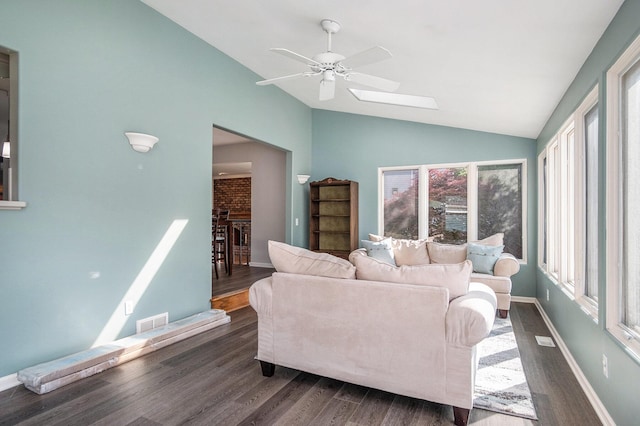 2104 Waterbury Dr SE, Kentwood, MI 49508 - living room featuring lofted ceiling, ceiling fan, dark wood-style flooring, and a skylight
