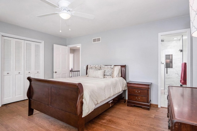 2104 Waterbury Dr SE, Kentwood, MI 49508 - bedroom with light wood-style flooring, a closet, ceiling fan, and ensuite bath