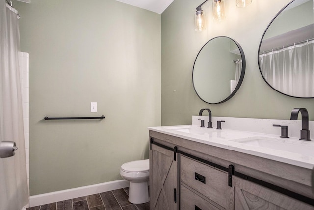 2104 Waterbury Dr SE, Kentwood, MI 49508 - bathroom with double vanity, wood tiled floors, and a shower with shower curtain