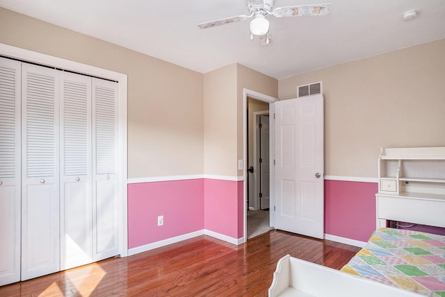 2104 Waterbury Dr SE, Kentwood, MI 49508 - bedroom with wood finished floors, a ceiling fan, and a closet