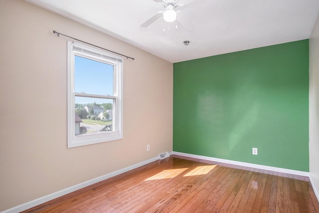 2104 Waterbury Dr SE, Kentwood, MI 49508 - unfurnished room with hardwood / wood-style flooring, ceiling fan, and fire sprinkler in ceiling