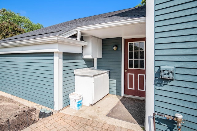 2104 Waterbury Dr SE, Kentwood, MI 49508 - view of exterior entry with a shingled roof