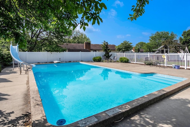 2104 Waterbury Dr SE, Kentwood, MI 49508 - view of pool featuring a water slide, a patio area, and a diving board