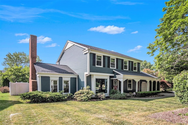 2104 Waterbury Dr SE, Kentwood, MI 49508 - traditional home featuring a front lawn and a chimney