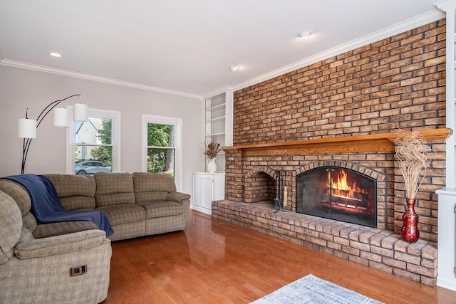 2104 Waterbury Dr SE, Kentwood, MI 49508 - living area featuring a fireplace, wood finished floors, ornamental molding, and recessed lighting