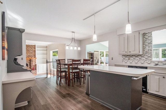 2104 Waterbury Dr SE, Kentwood, MI 49508 - kitchen with dishwasher, light countertops, dark wood-style floors, and decorative backsplash