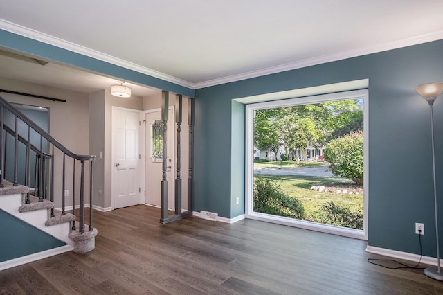 2104 Waterbury Dr SE, Kentwood, MI 49508 - entrance foyer with dark wood-type flooring, crown molding, and stairs