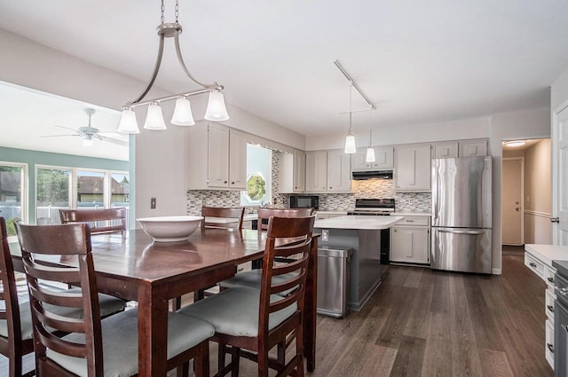 2104 Waterbury Dr SE, Kentwood, MI 49508 - kitchen featuring freestanding refrigerator, stove, light countertops, under cabinet range hood, and black microwave