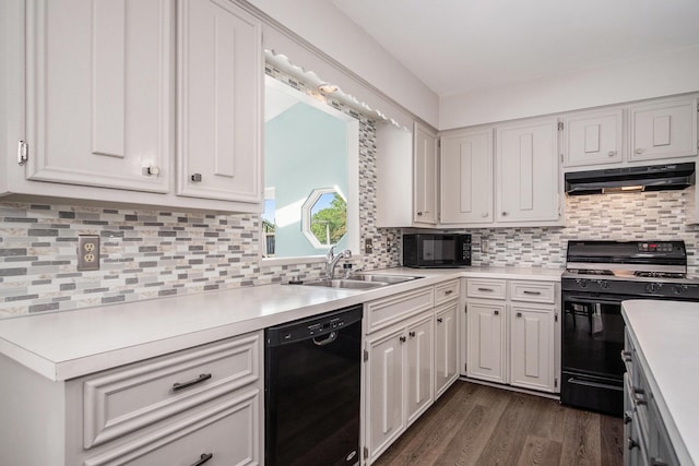 2104 Waterbury Dr SE, Kentwood, MI 49508 - kitchen with black appliances, under cabinet range hood, light countertops, dark wood-style floors, and tasteful backsplash