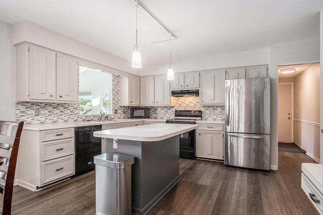 2104 Waterbury Dr SE, Kentwood, MI 49508 - kitchen with black appliances, under cabinet range hood, light countertops, backsplash, and a kitchen island