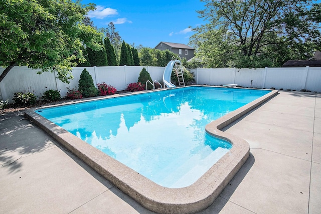 2104 Waterbury Dr SE, Kentwood, MI 49508 - view of pool with a water slide, a fenced backyard, and a patio area