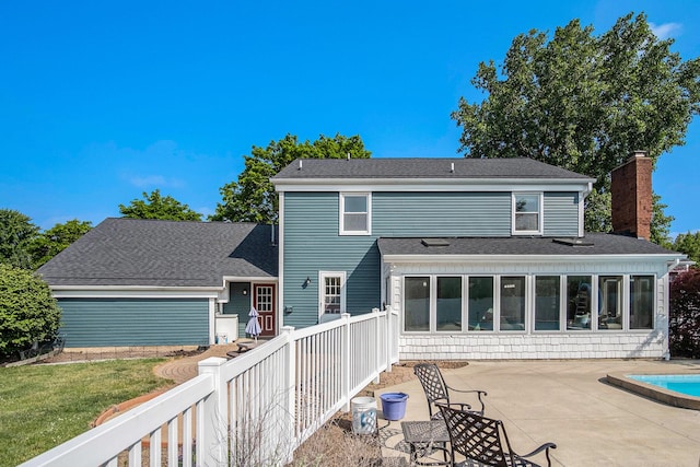 2104 Waterbury Dr SE, Kentwood, MI 49508 - rear view of house with a patio area, a chimney, a sunroom, an outdoor pool, and a shingled roof