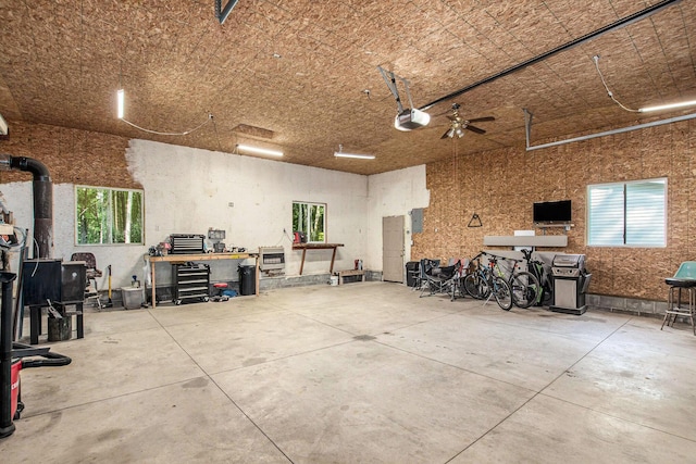 12467 S Running Deer Ln, Grant, MI 49327 - garage with a garage door opener and a workshop area