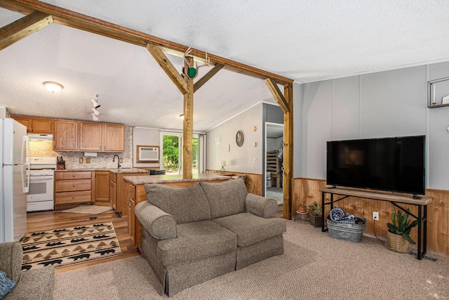 12467 S Running Deer Ln, Grant, MI 49327 - living room with a wainscoted wall, a textured ceiling, wooden walls, and a wall mounted AC