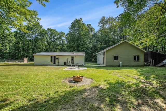 12467 S Running Deer Ln, Grant, MI 49327 - rear view of property featuring a fire pit, a metal roof, and a patio area