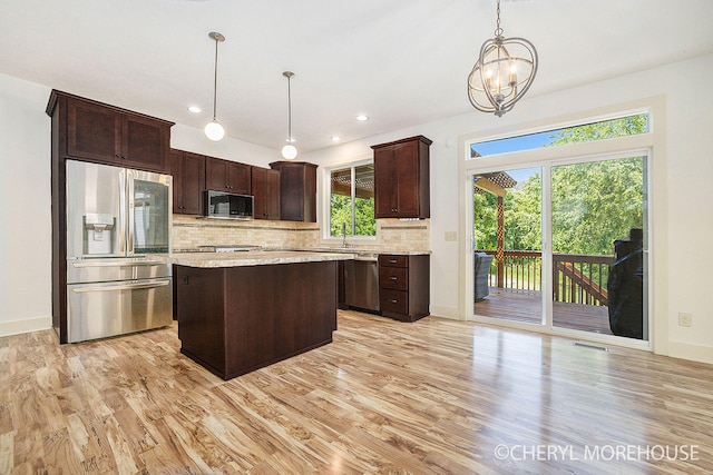 7511 Emerald Woods SE, Byron Center, MI 49315 - kitchen with stainless steel appliances, backsplash, dark brown cabinets, light wood-style floors, and recessed lighting