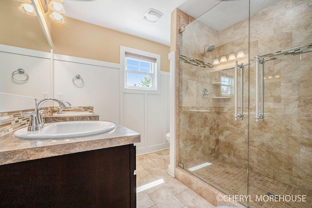 7511 Emerald Woods SE, Byron Center, MI 49315 - bathroom featuring double vanity and a shower stall